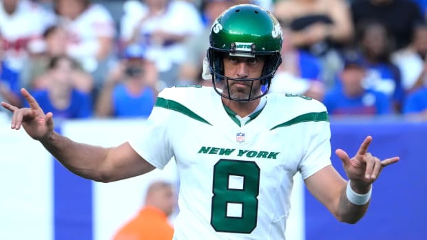 Jets quarterback Aaron Rodgers gestures to a crowd of fans ahead of a preseason game against the Giants.